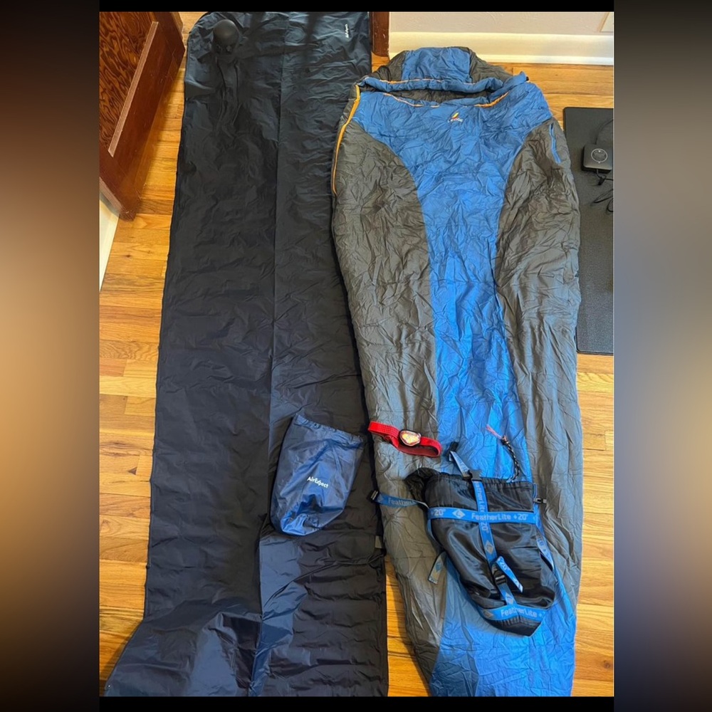 Sleeping bag with sleeping pad and camping light